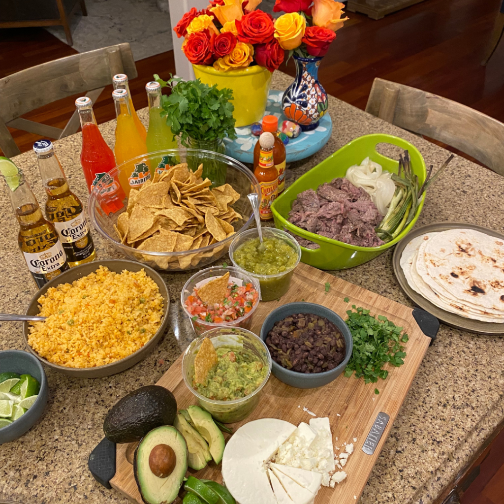 Arrachera taco dinner spread of garnishes and side dishes as Cinco de Mayo party ideas